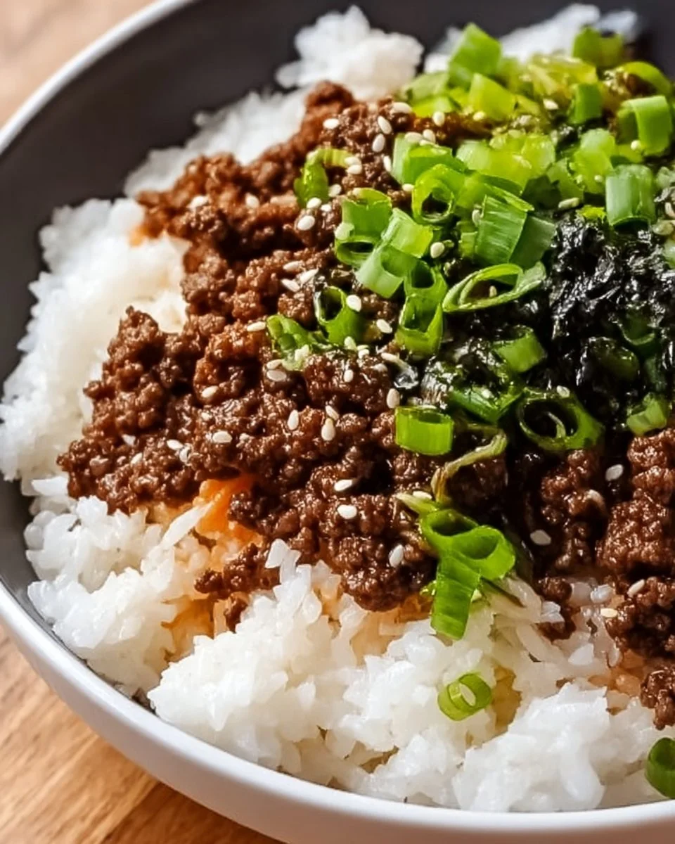 Korean Ground Beef Bowl topped with fresh vegetables and served in a stylish bowl.
